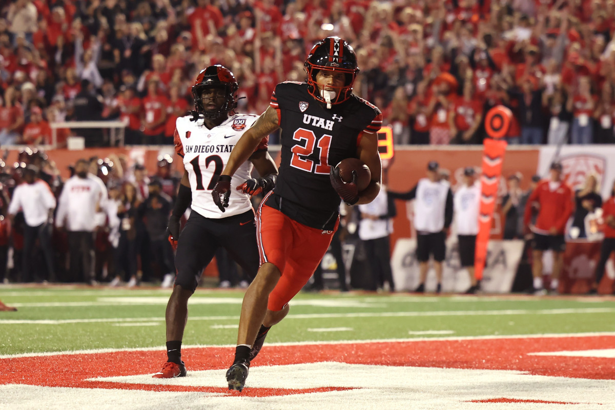 Utah Utes wide receiver Solomon Enis (21) scores a touchdown against San Diego State Aztecs cornerback Dallas Branch (12) in the second quarter at Rice-Eccles Stadium.